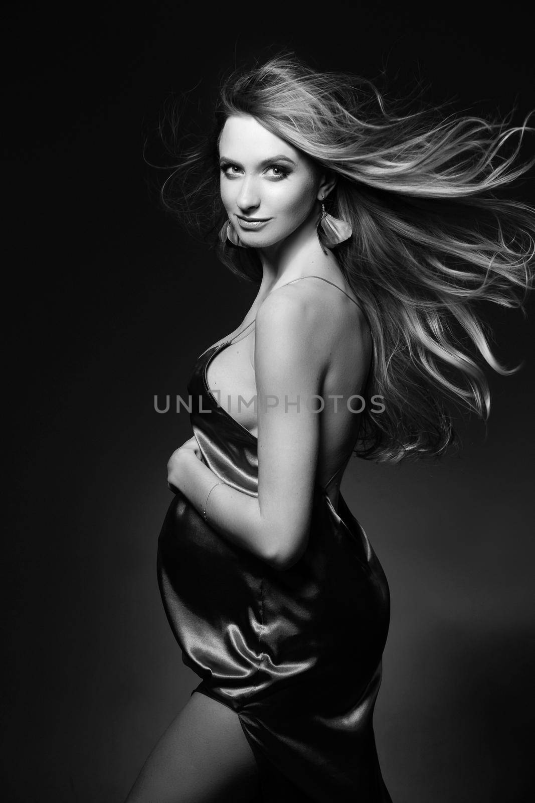 Monochrome portrait of gorgeous pregnant woman in silk dress. by StudioLucky