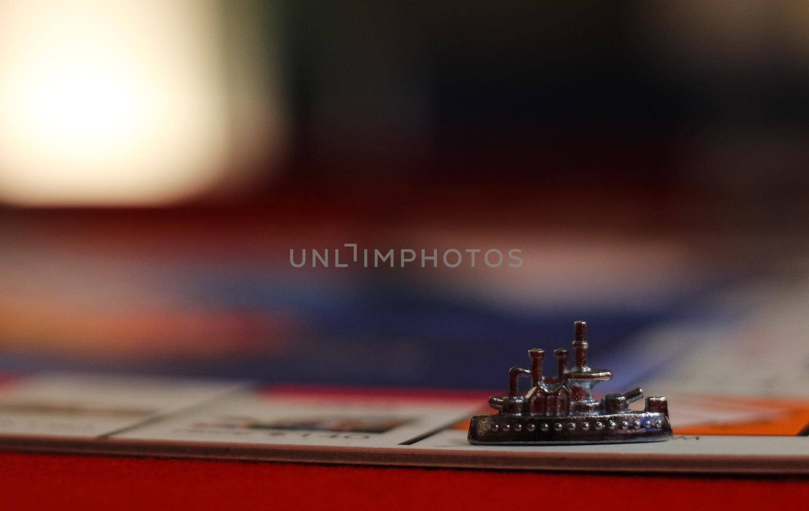 Metal ship game board piece preceding a blurred background, Hampshire, UK. High quality photo.