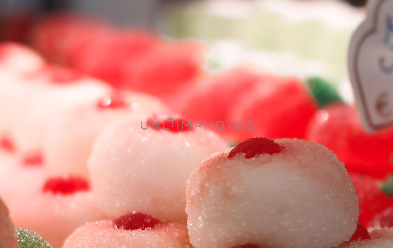 Close up of a row of sugary cherry jelly sweets and candy in a store window, Florence, Italy. High quality photo.
