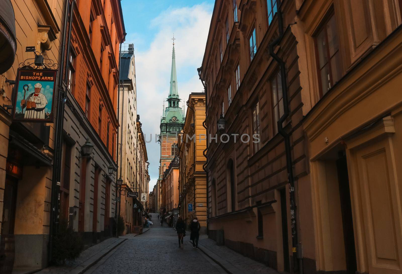 Dark traditional Swedish street, heading towards the church in Gamla Stan, Stockholm, Sweden. by olifrenchphoto
