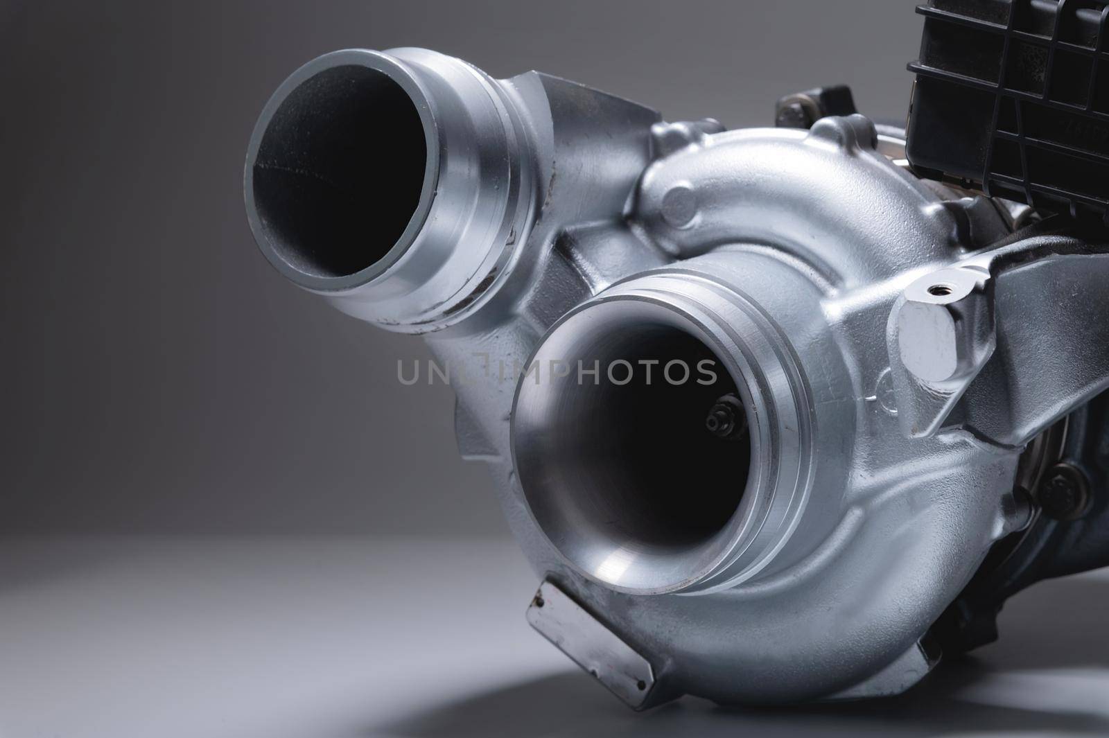 New car turbine on a gray background. Blower for air intake system.