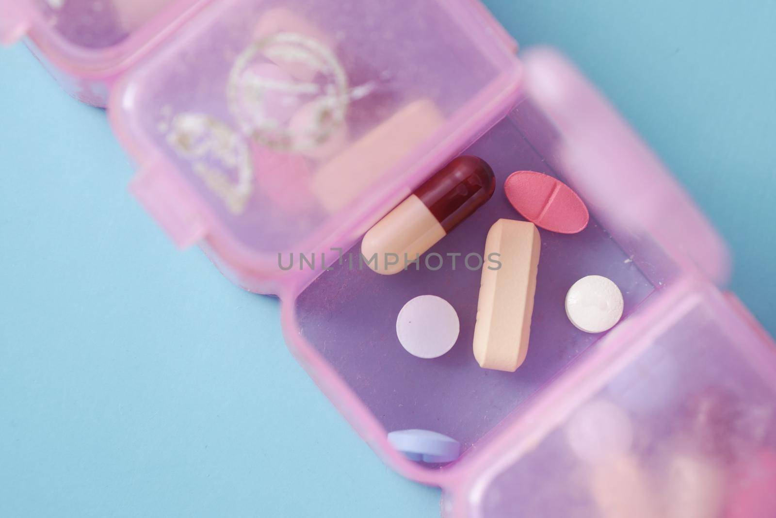 top view of medical pills in a pill box on color background ,
