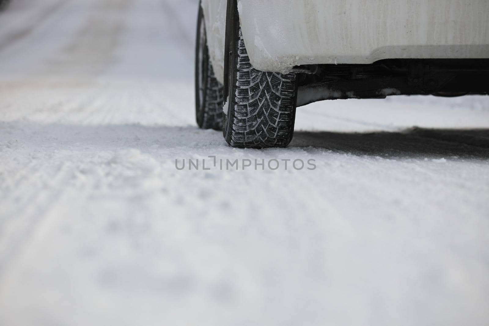 Close up of Winter Tire on Snow and Ice Covered Road by markvandam