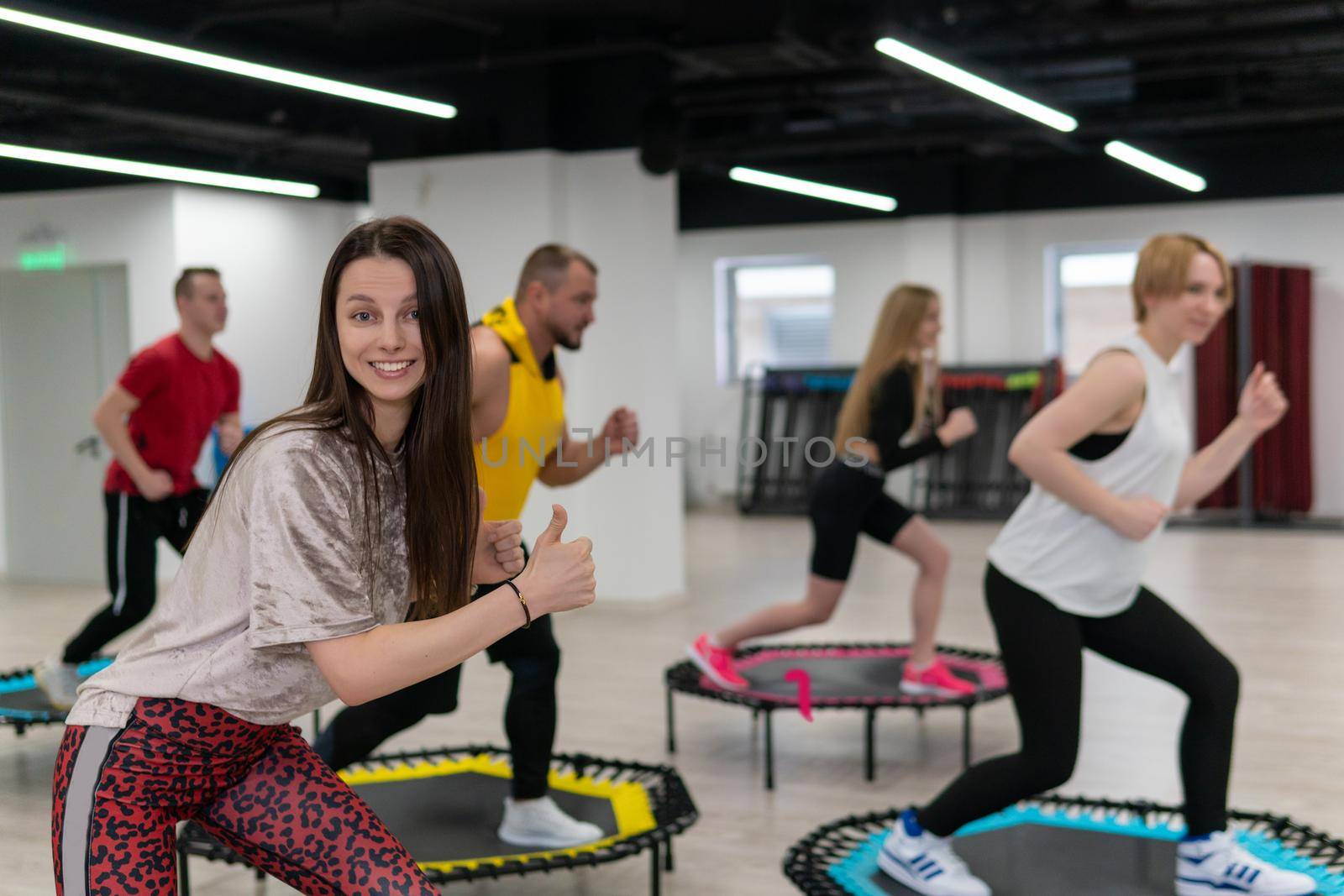 Women's and men's group on a sports trampoline, fitness training, healthy life - a concept trampoline group batut girl men, from fit activity for sporty and sport shaping, wellness happiness. Studio beauty loss, aerobic by 89167702191