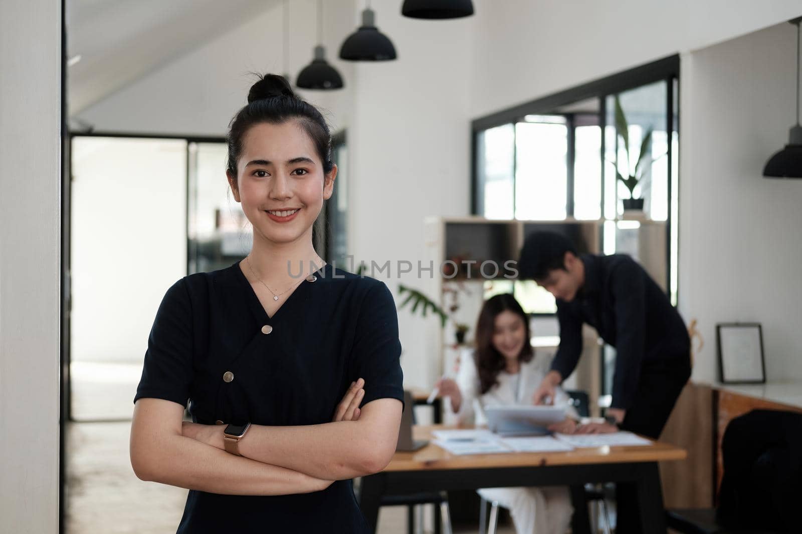 Confident of beautiful asian businesswoman standing in office arms crossed.