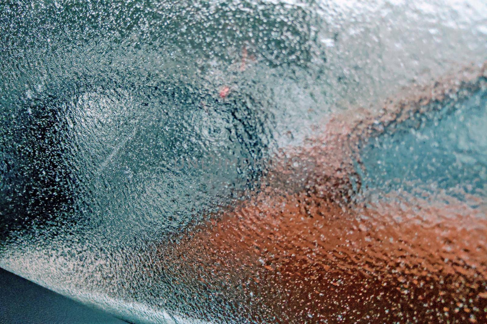 Ice covered car glass after night. Climate.