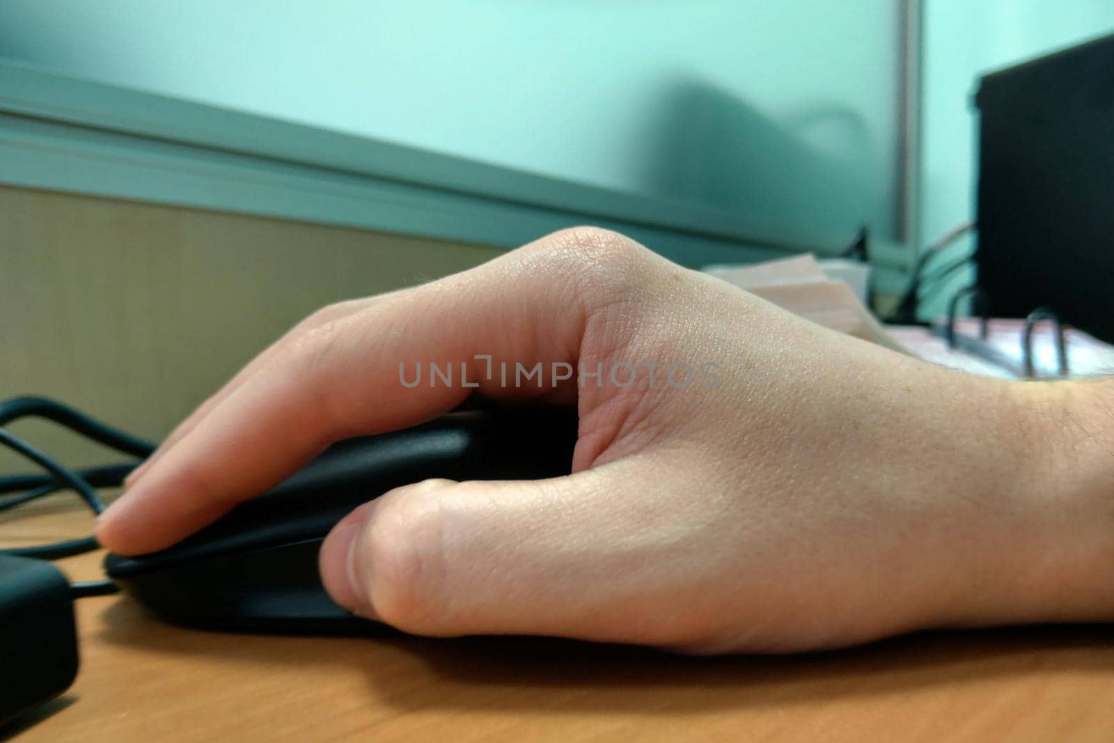 Image of male hands pushing keys of a computer mouse