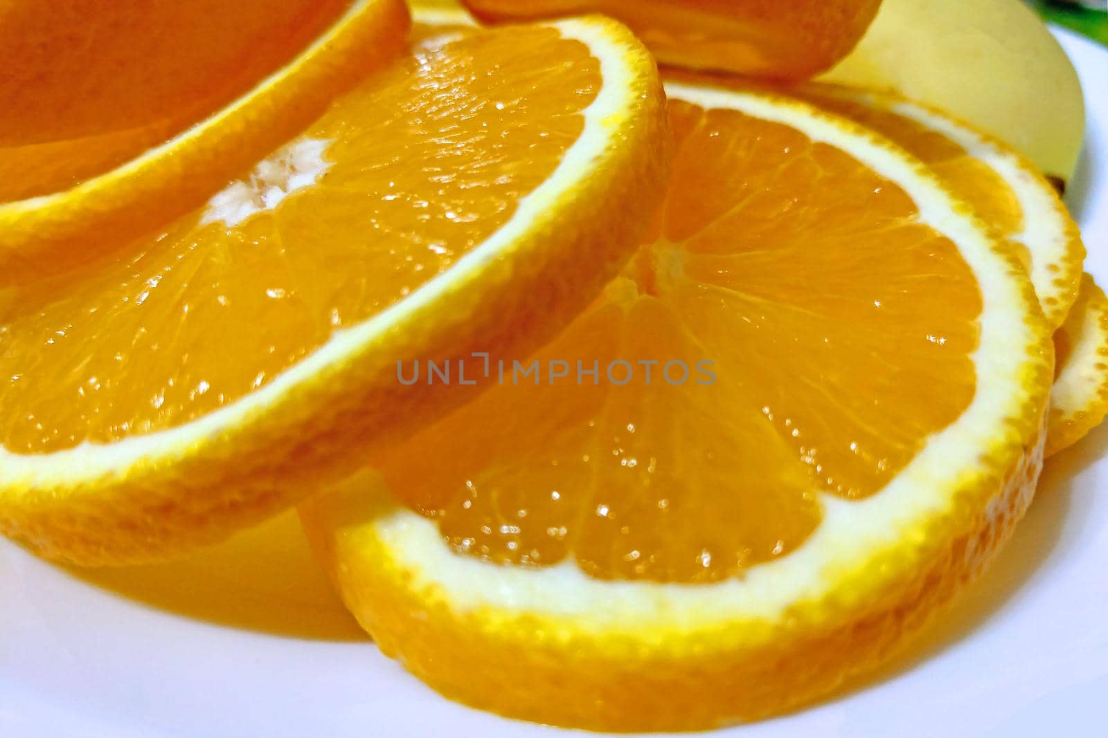 Slices of juicy bright yellow orange close-up. Background