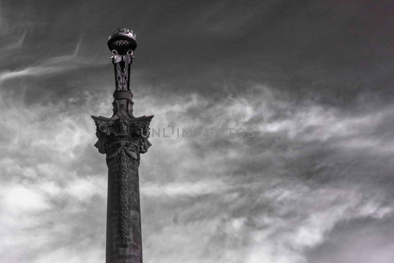 Black and white, moody infrared photograph of ornately decorated tower framed by dramatic cirrus clouds Yorkshire, England, UK