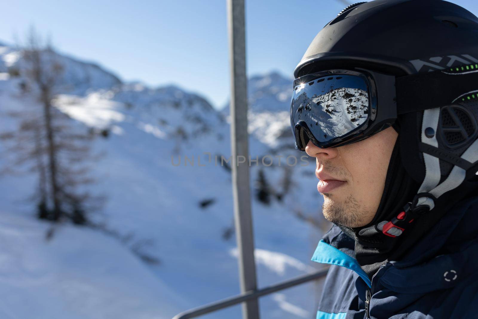 ski resort man on chairlift in helmet and mask by Chechotkin