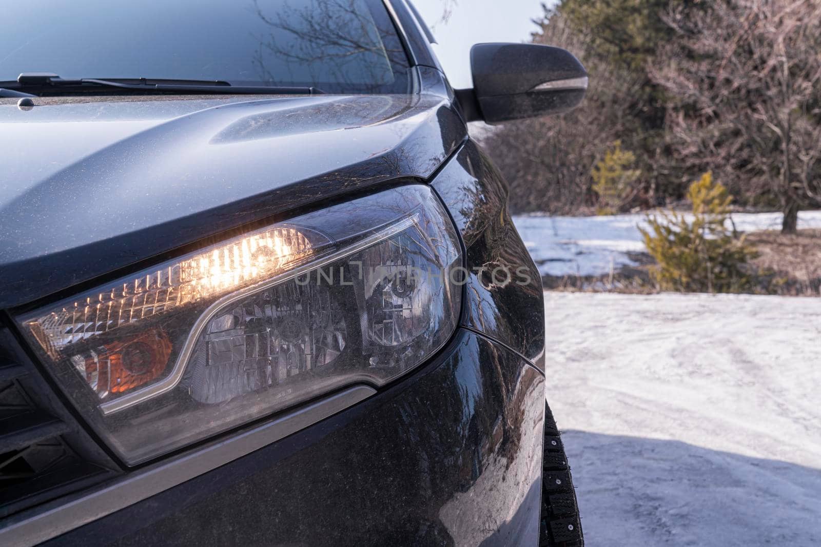 car in winter in the forest close-up by roman112007