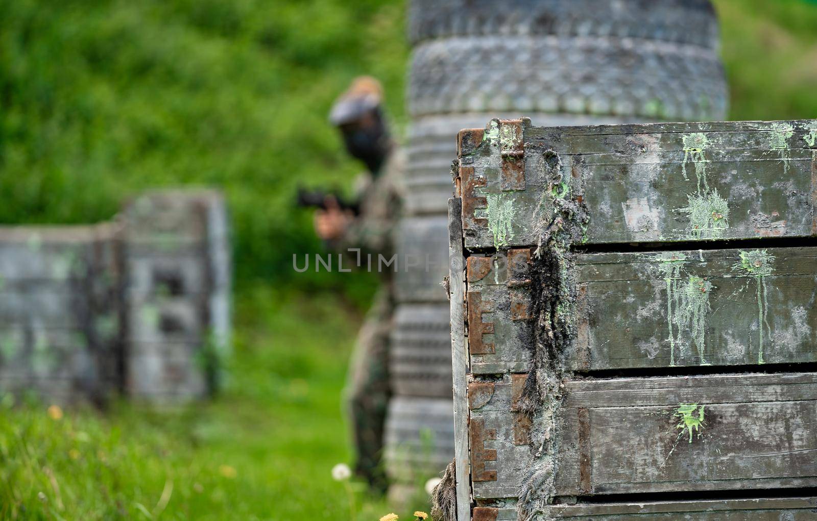 woman in uniform with a gun in military paintball training by Edophoto