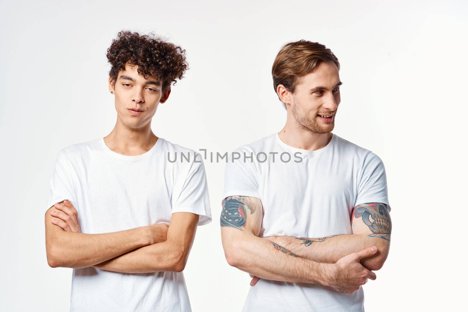 two friends in white t-shirts together lifestyle emotions fun. High quality photo