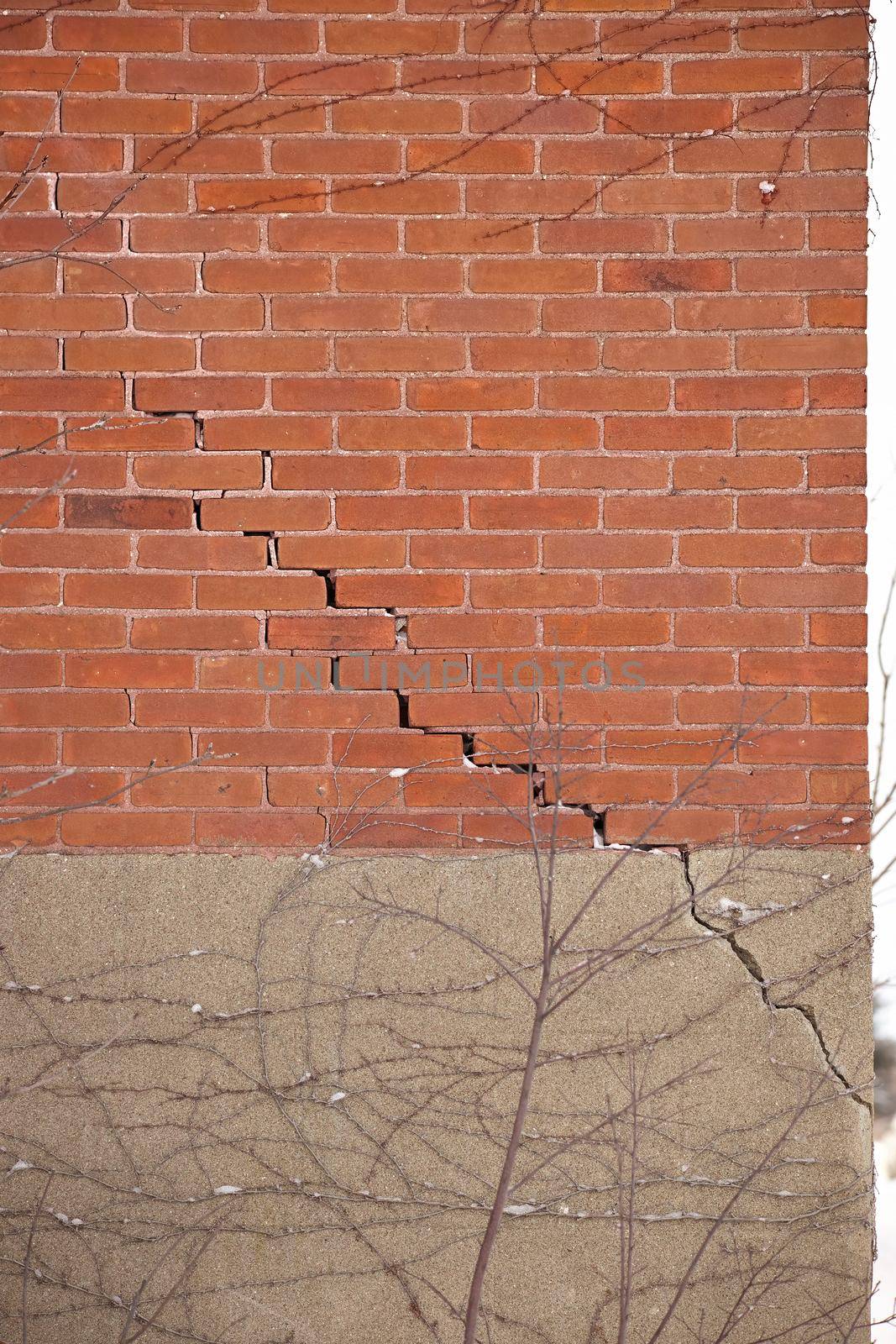 Red Brick Wall and Foundation with Large Crack and crumbling mortar by markvandam