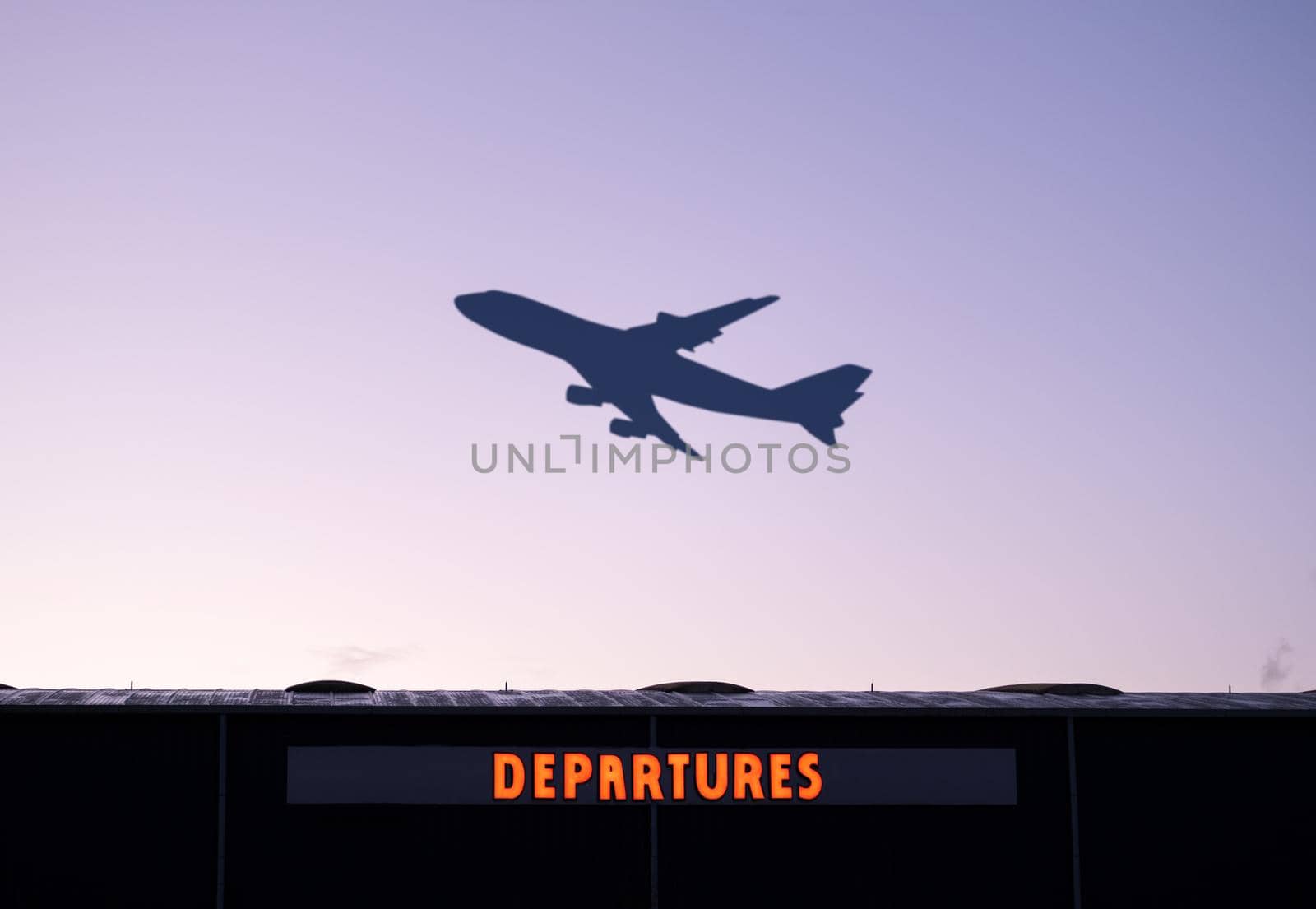 An Airplane Taking Off At Sunset With The Airport Departures Building In The Foreground