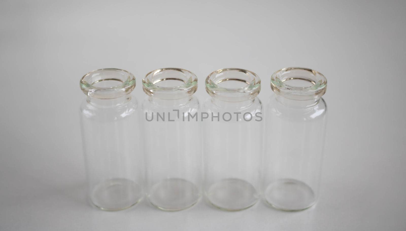 Empty glass bottles for storing medicines, liquids on a white background by lapushka62