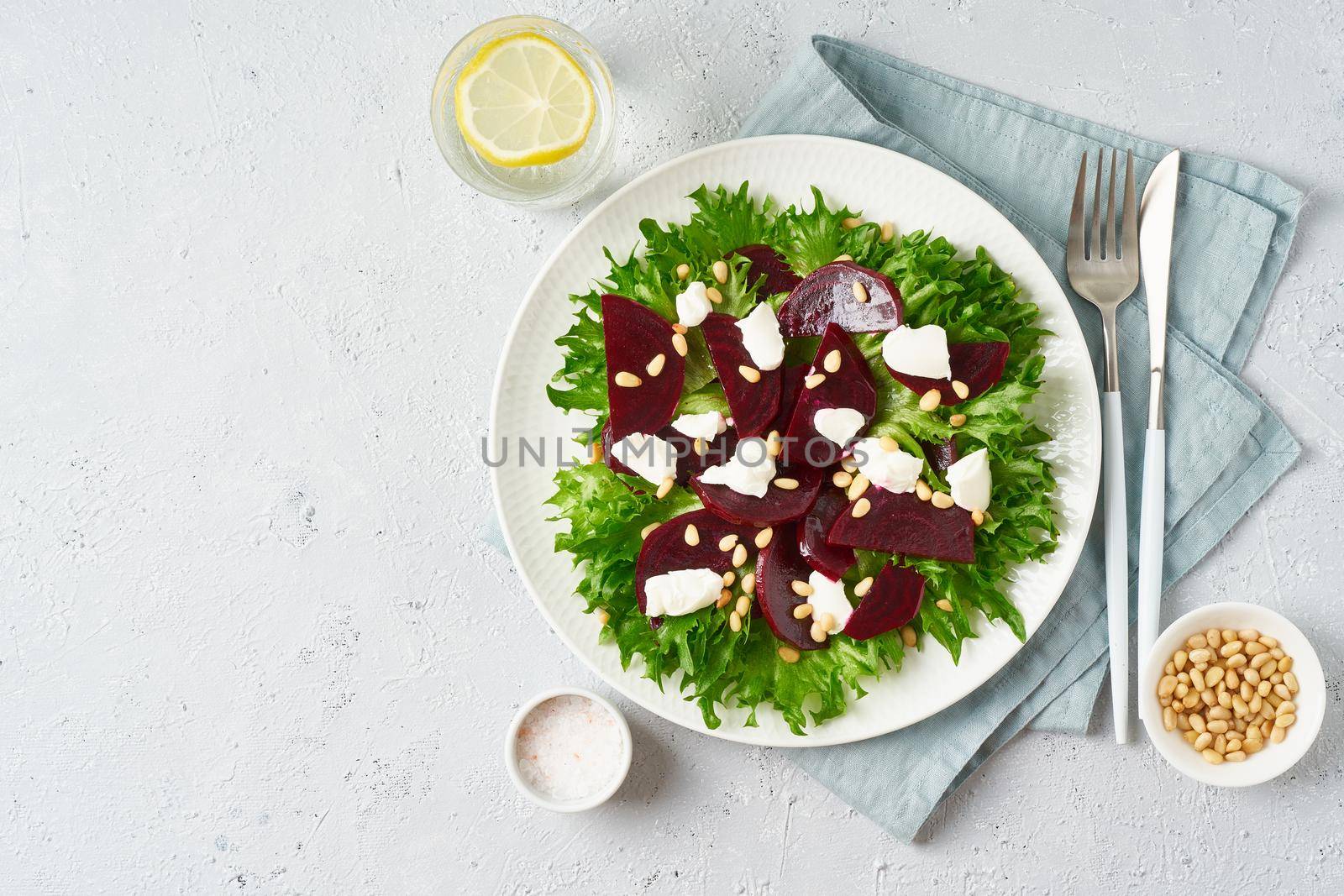 salad with beet, curd, feta, ricotta and pine nuts, lettuce. Healthy keto ketogenic dash diet, top view, copy space