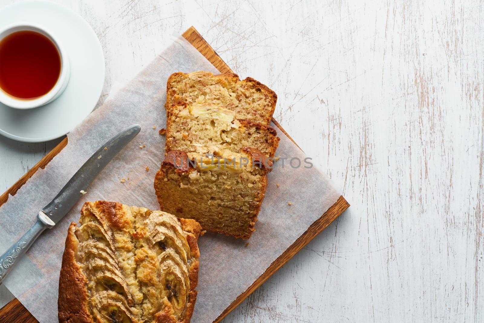 Banana bread. Cake with banana, traditional american cuisine. Slice of loaf. Top view, close up.