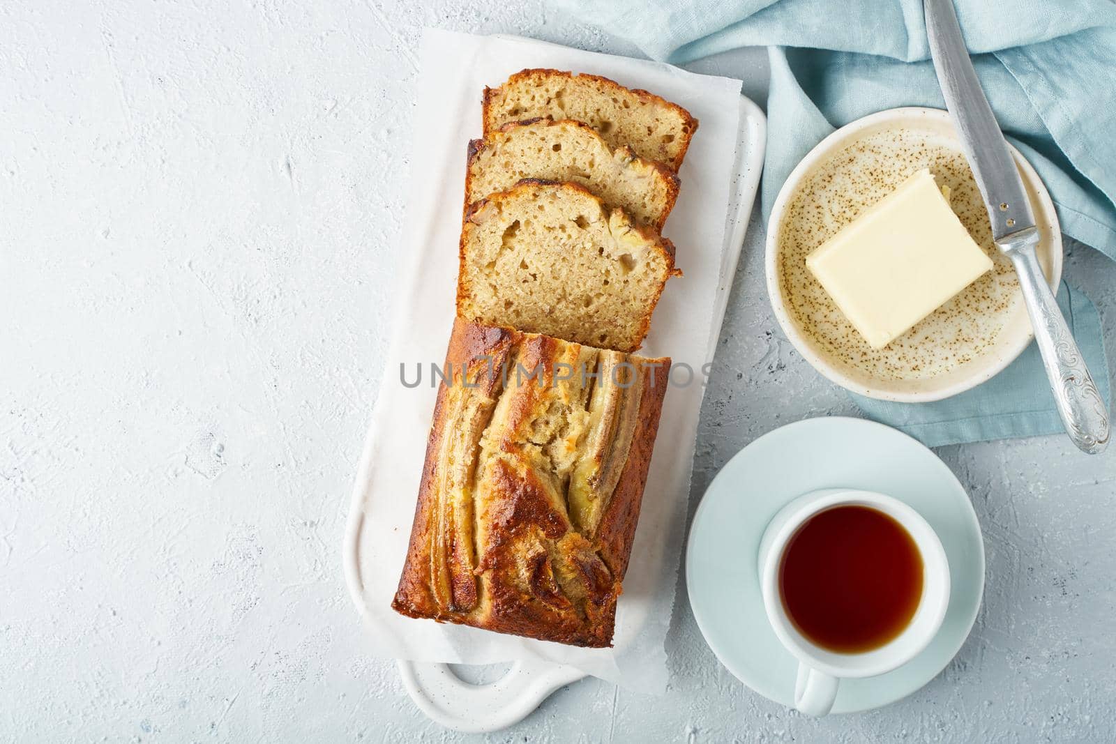 Banana bread. Cake with banana, traditional american cuisine. Slice of loaf. Gray background, copy space. Top view