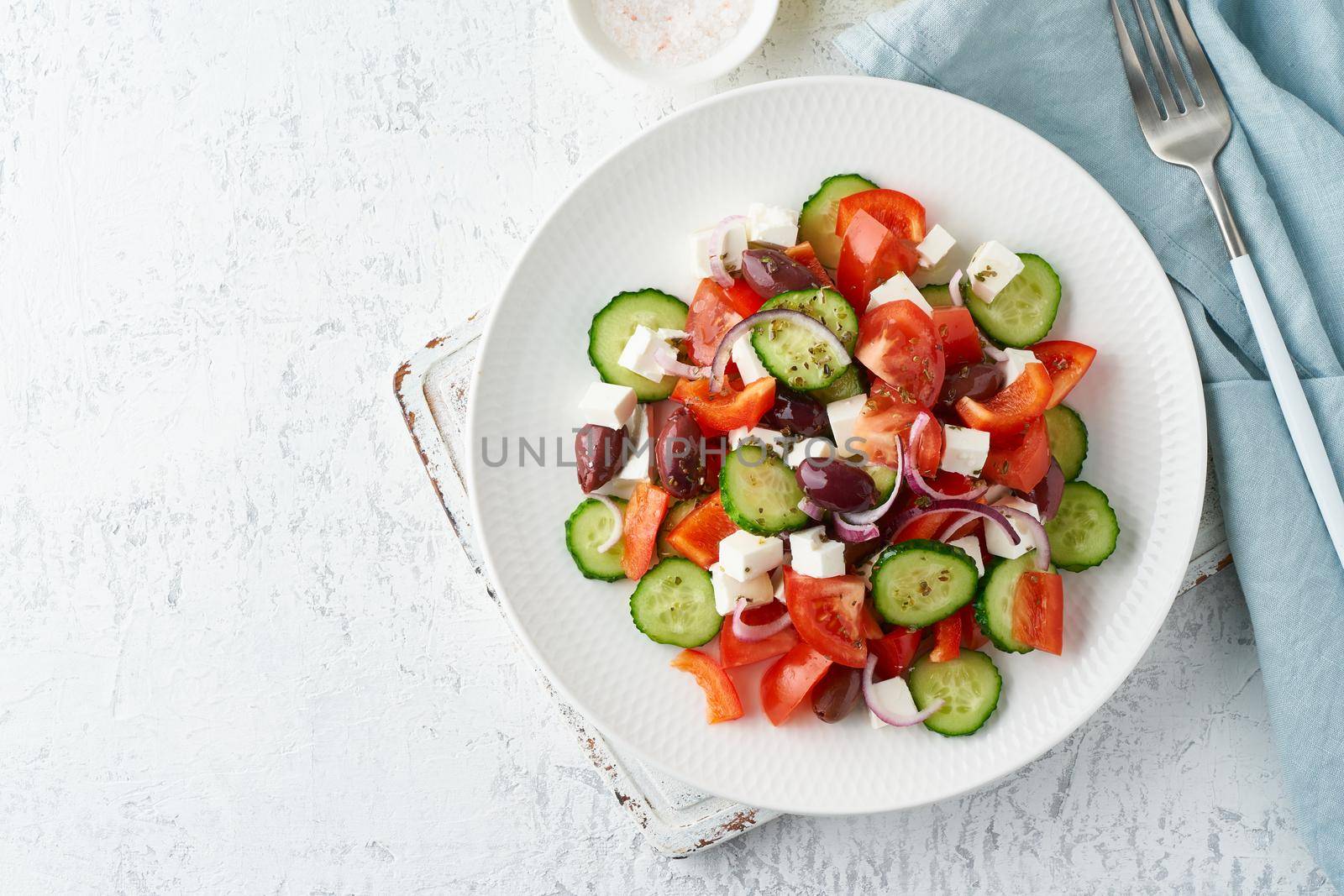 Greek village salad horiatiki with feta cheese, olives, cherry tomato, cucumber and red onion by NataBene