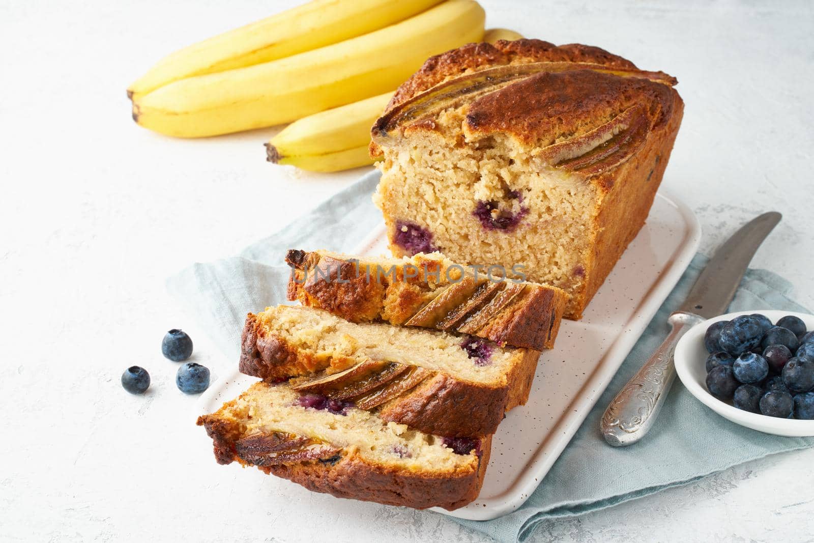 Homemade Banana bread. Baked cake. Top view, white table. Traditional american cuisine. Slice of loaf.