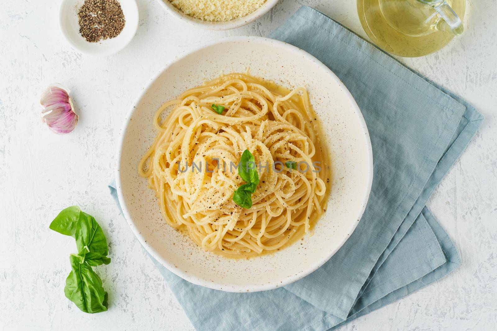 Cacio e pepe pasta. Spaghetti with parmesan cheese and pepper. Traditional italian cuisine. Top view,