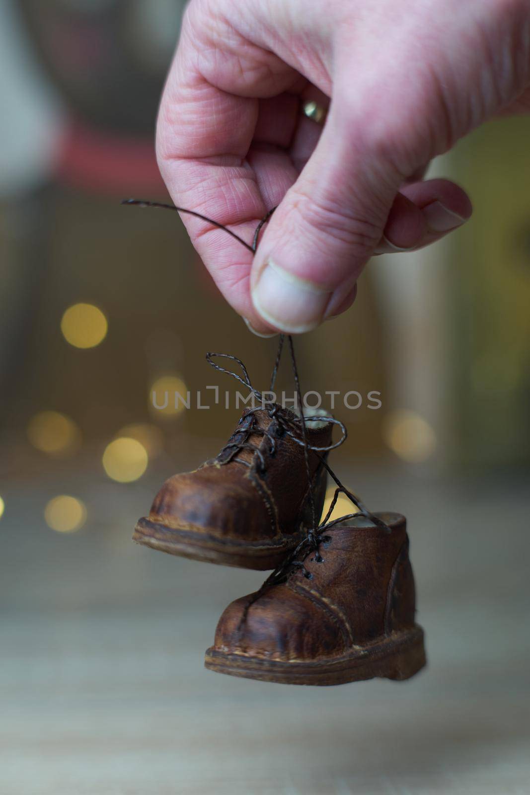 the concept of light industry for the manufacture of stylish fashionable brown leather small shoes with small feet for teddy bears or dolls and for children and their parents. High quality photo