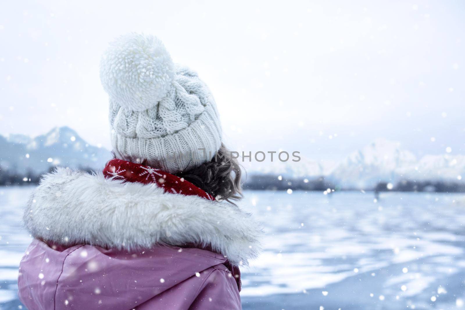 The charming Lady looks thoughtfully into the distance. She is dreaming about someone. The ice in the frozen lake shifting and make amazing noises. The acoustics of the frozen lake creates a dream