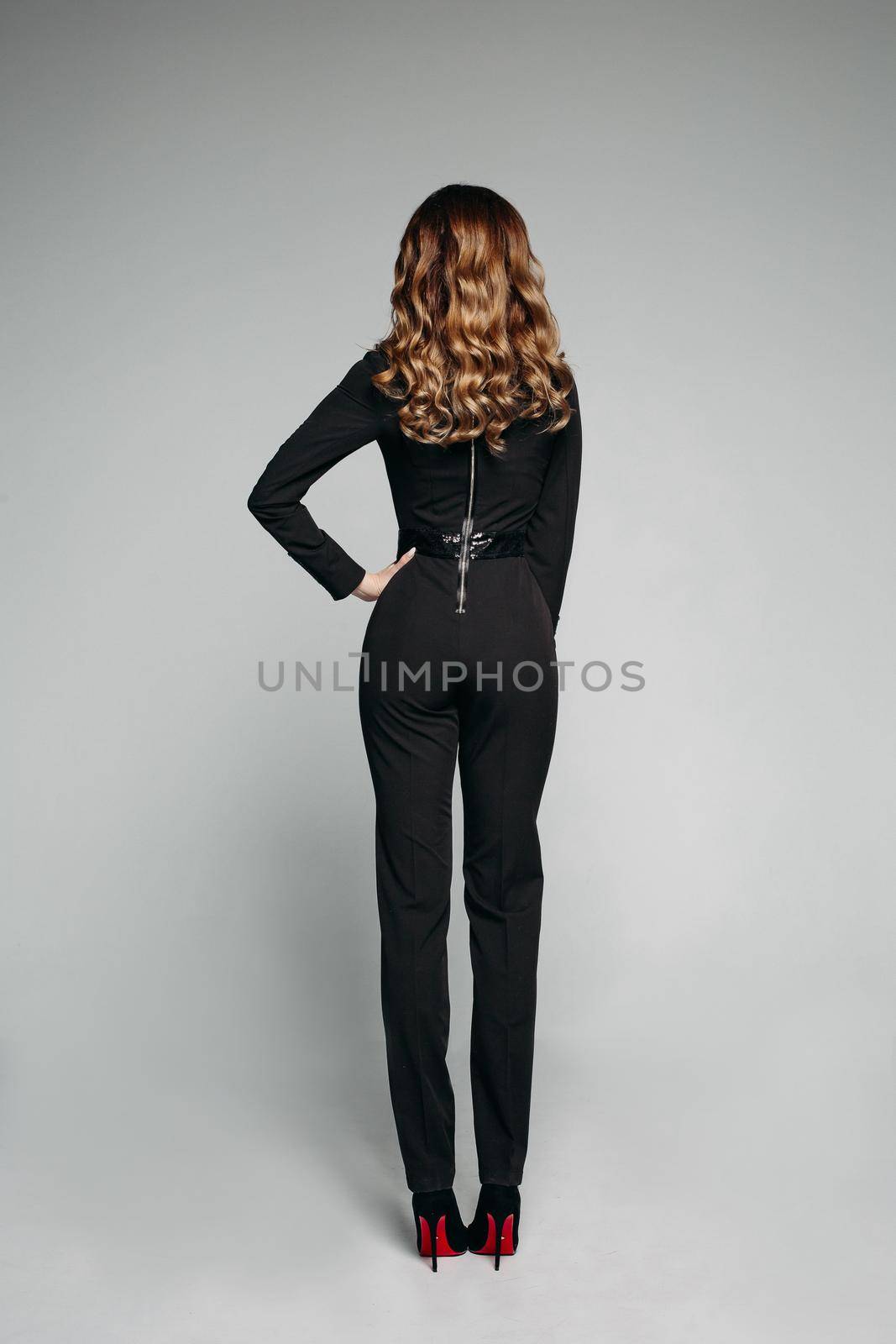 Fashion concept shoot. Model in black classic overall with element of design on back. by StudioLucky