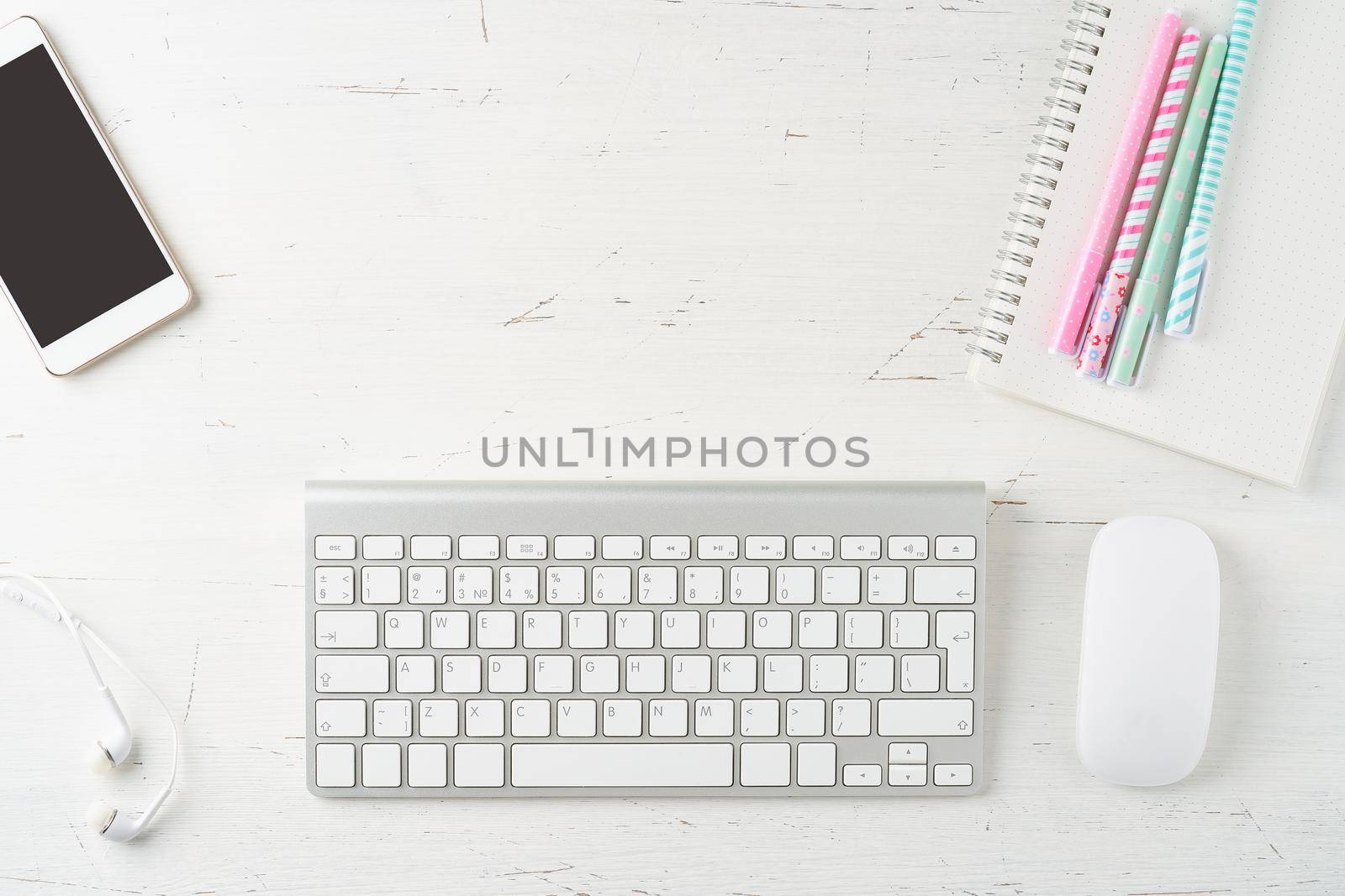 Work from home, online learning. Top view. Distance education. Female desk. Copy space, mock up. Freelancer, Digital nomad concept. Keyboard and mobile phone on table