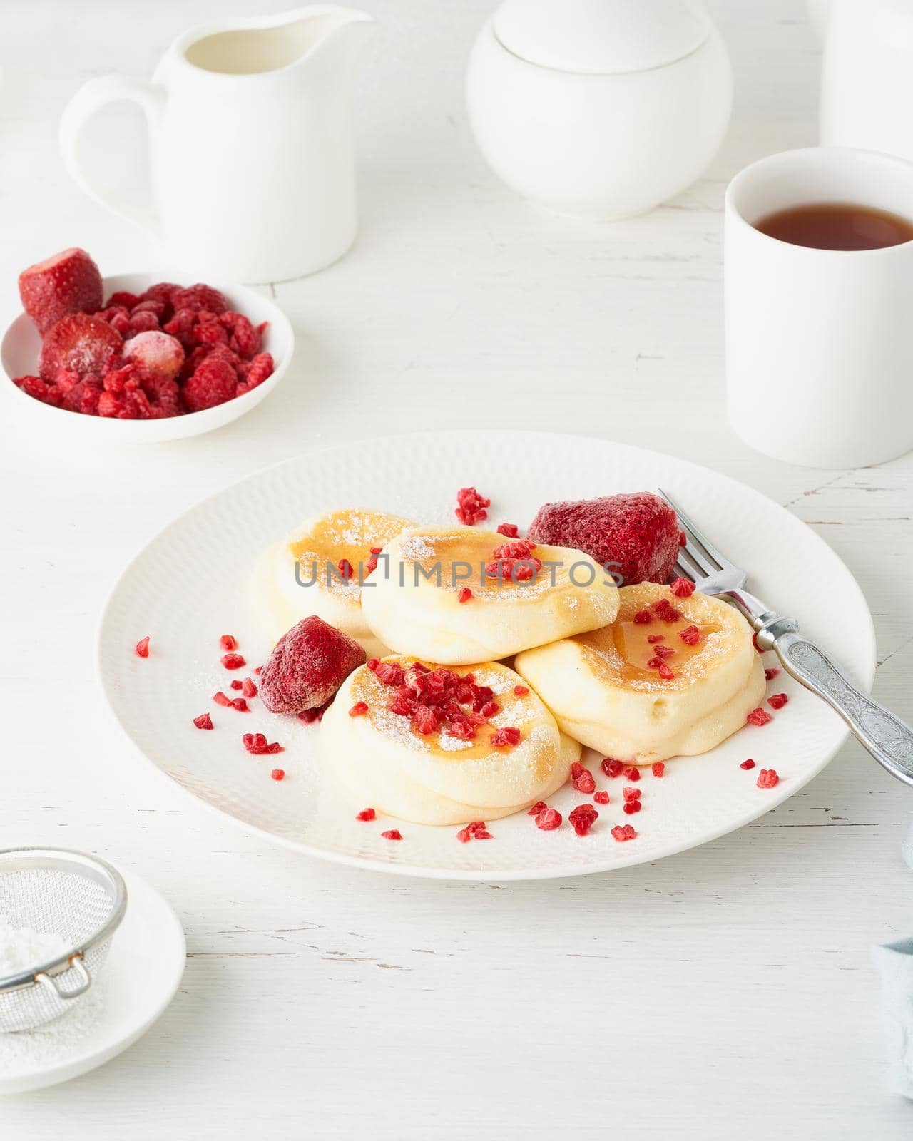 Fluffy japanese pancake, thick souffle. Trendy food. Delicious Breakfast on a white background. Side view, vertical