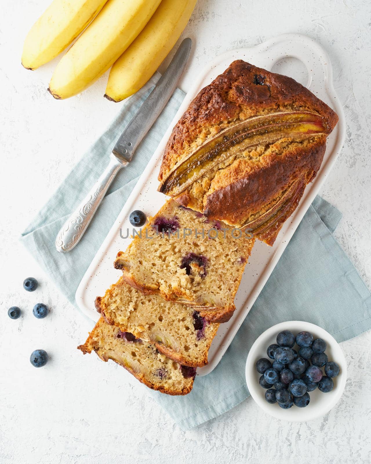 Homemade Banana bread. Baked cake. Step by step recipe. Step 13. Top view, white table. Traditional american cuisine. Slice of loaf.