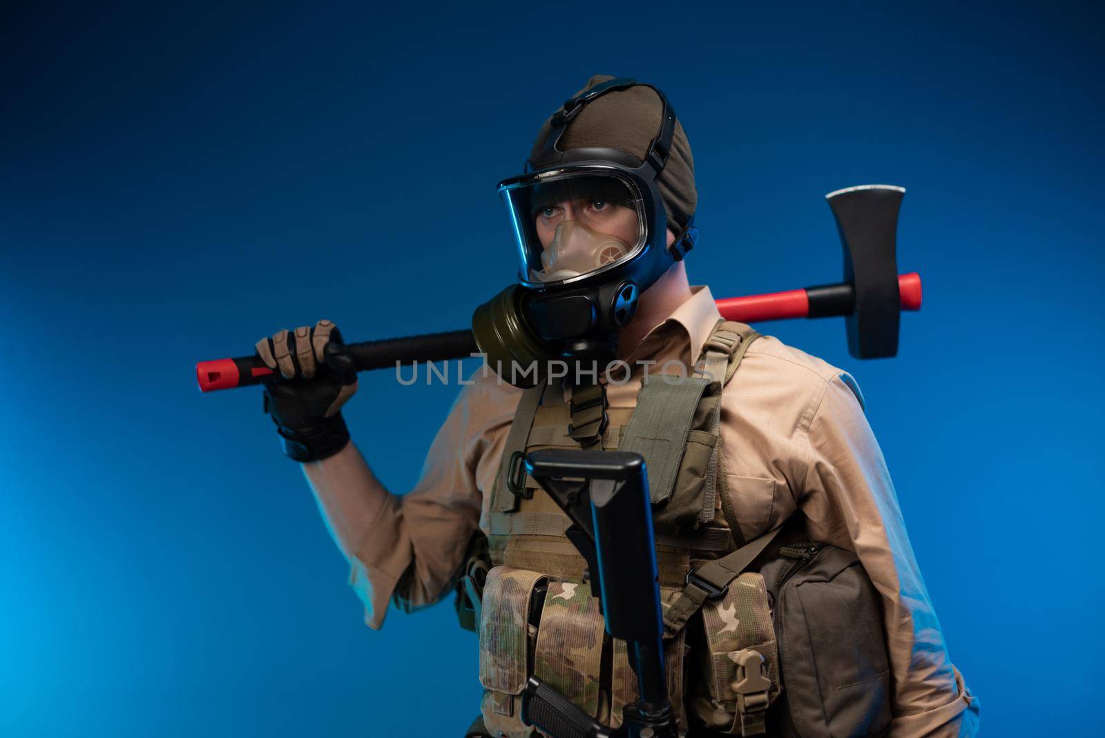 a man in military clothes and a gas mask with a red fire axe on his shoulder by Rotozey