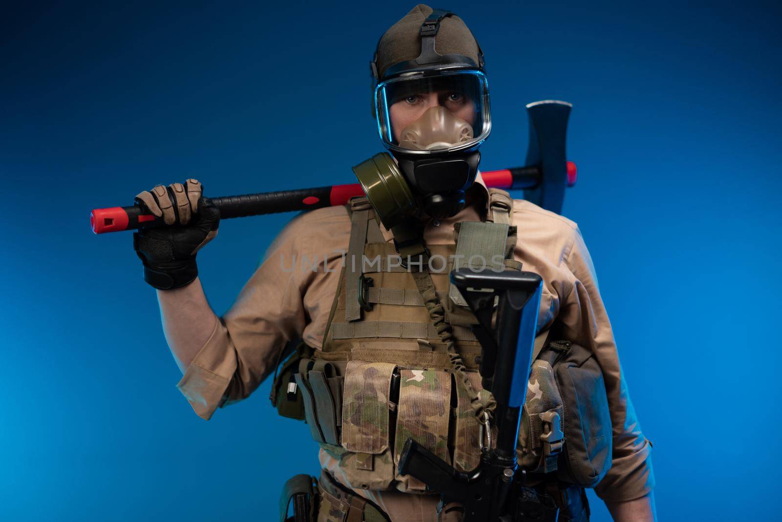 a man in military clothes and a gas mask with a red fire axe on his shoulder