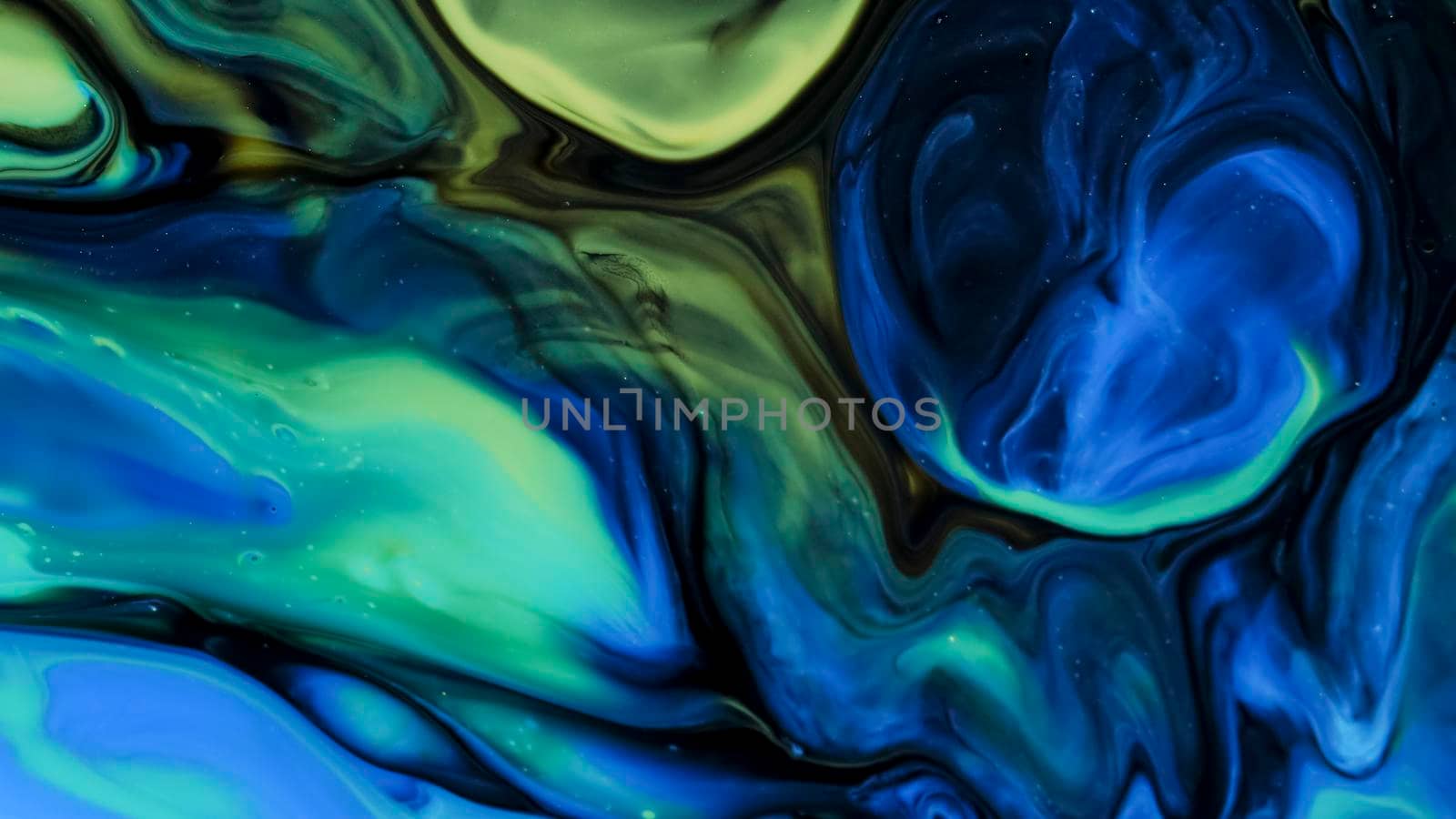 Fluid paint art, marble abstractions in blue, purple, black and yellow. Deep ink blanks. Abstract unique colorful background. Artistic painting of natural spreading. Abstract textural art. Liquid forms of design. Ink transitions. Colorful cell background, splash screen, background.