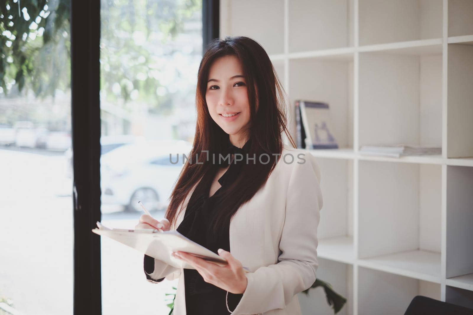 Asian Business woman working to analyze technical price graph and indicator. account or saving money or insurance concept. by itchaznong