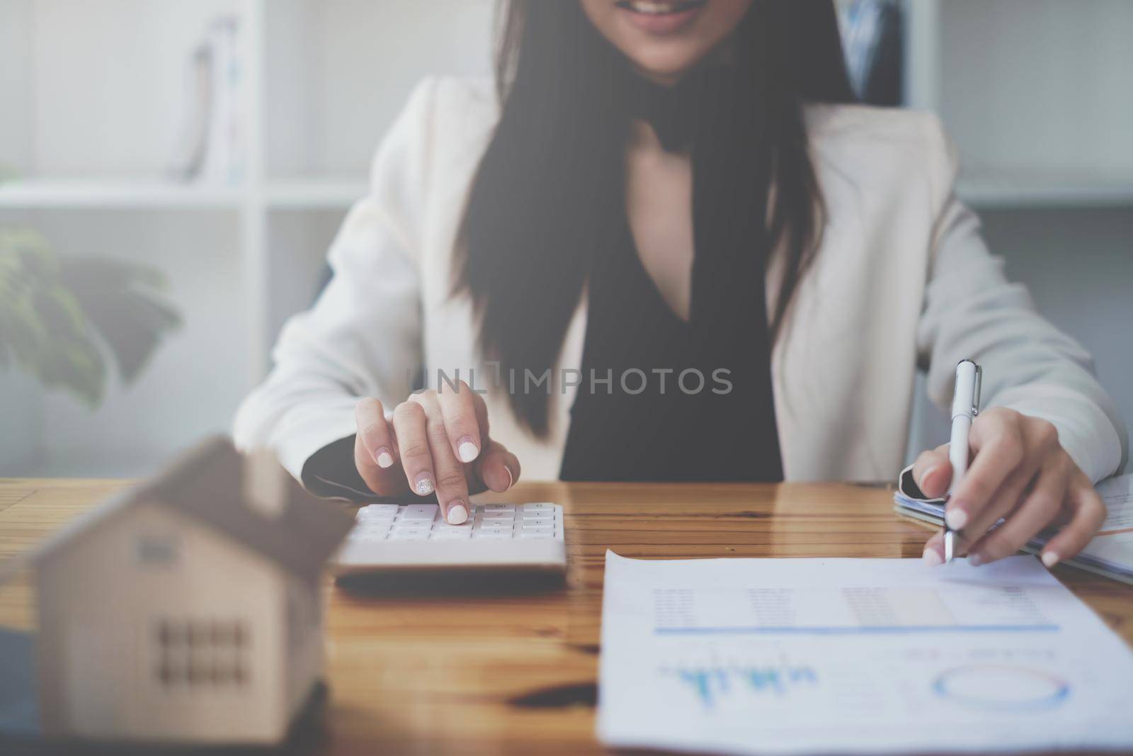 Asian Business woman or broker checking contract agreement paper with customer to sign contract. Real Estate and Agreement concept. by itchaznong