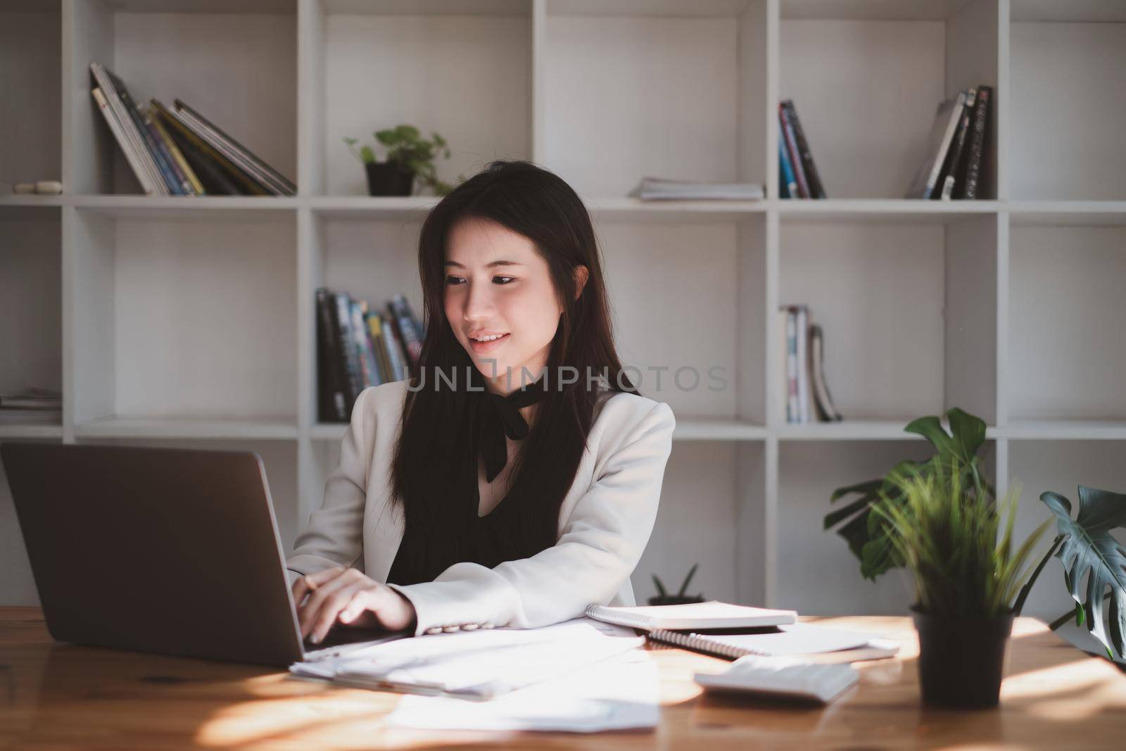 Asian Woman blogger wear blue suit talking with followers, live streaming on social media application. Freelance work from home concept. by itchaznong