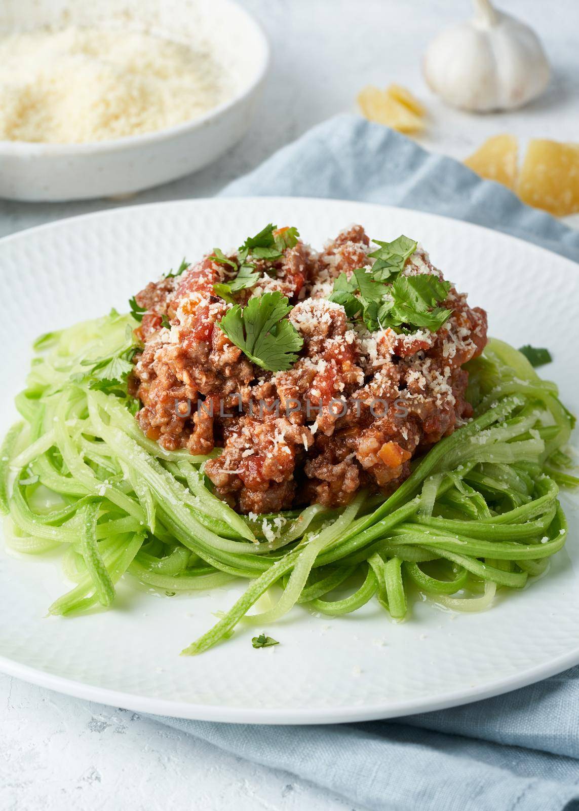 Keto pasta Bolognese with mincemeat and zucchini noodles, fodmap, lchf, low carb, ketogenic diet. Side view, close up. Clean eating, balanced food.