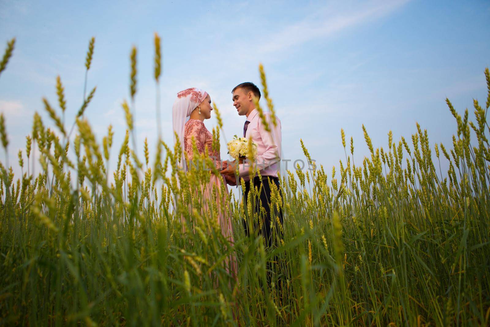 National wedding. Bride and groom in the field. Wedding muslim couple during the marriage ceremony. Muslim marriage.