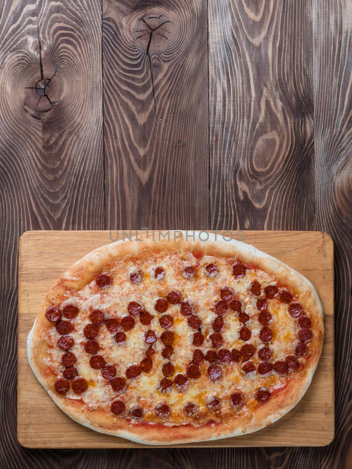 Father's day background. Pepperoni pizza with i love dad lettering on wooden tabletop. Father day concept, recipe and idea. Top view or flat-lay. Copy space for text. Vertical.