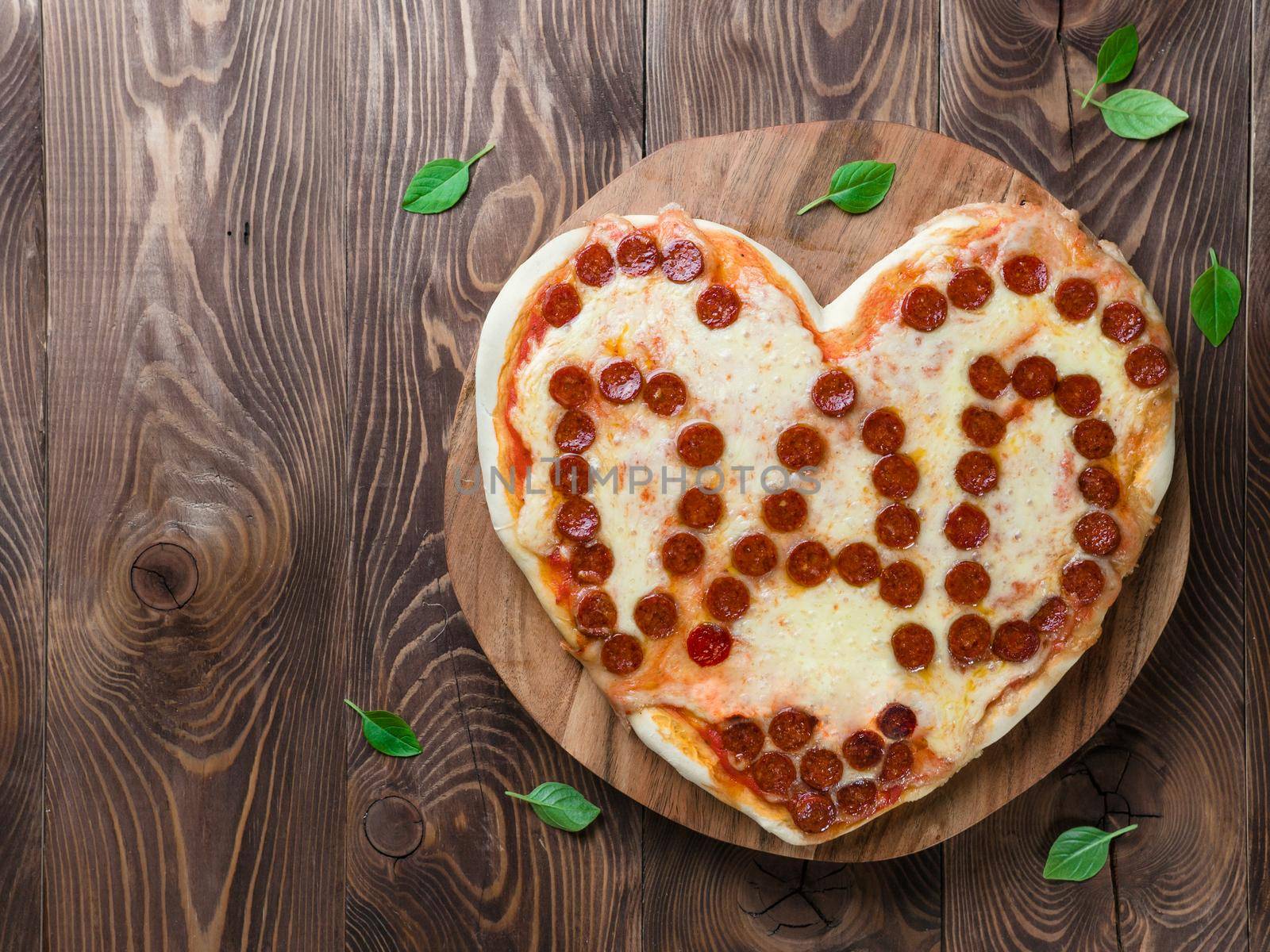 Pepperoni pizza in heart shape and dad word by fascinadora