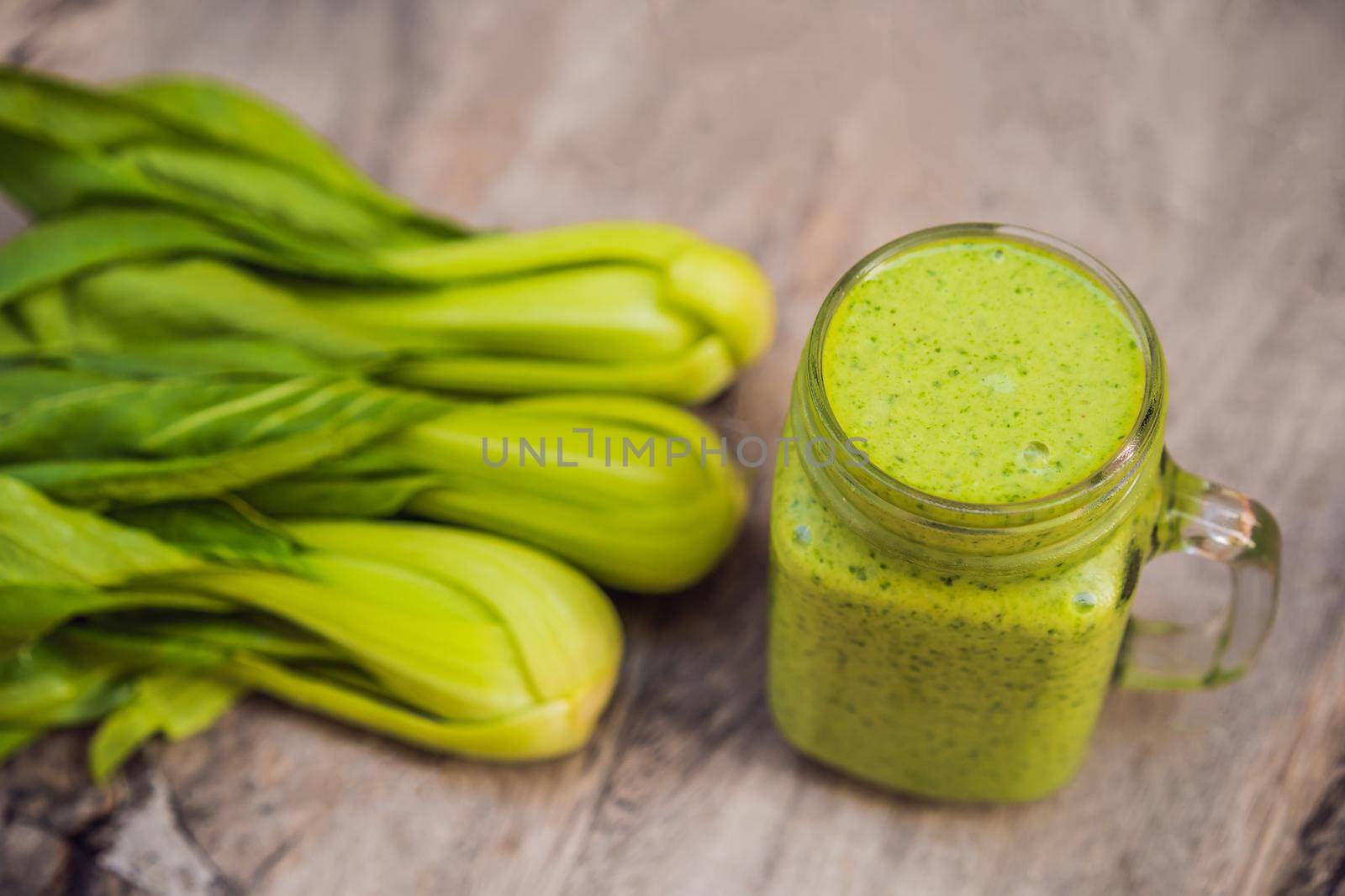 Ginger green apple smoothie on concrete background. It can be used as a background.