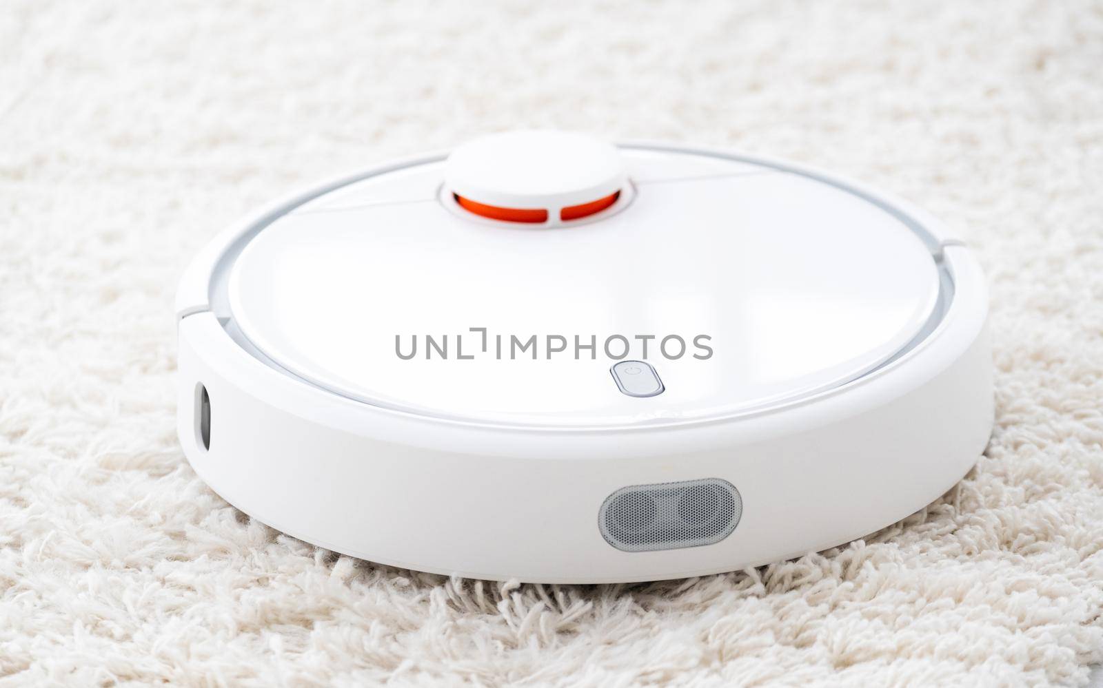 Wireless robot vacuum cleaner on white rug
