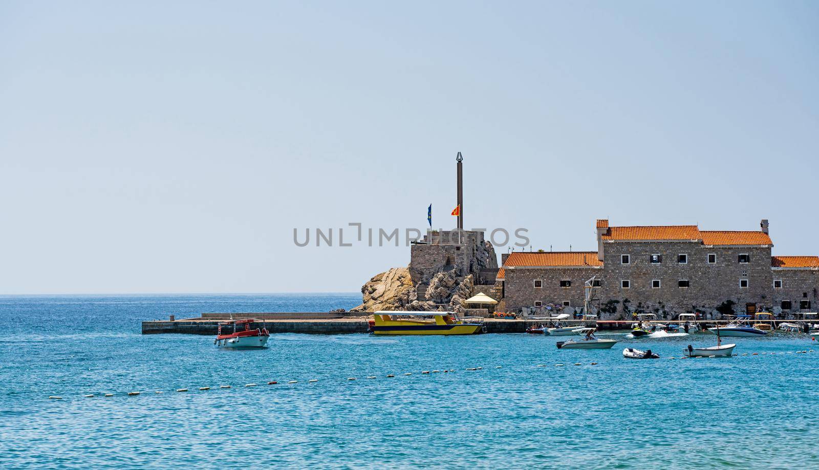 Yachts port in Montenegro in Adriatic sea. Boats pier in sunny day in Mediterranean sea