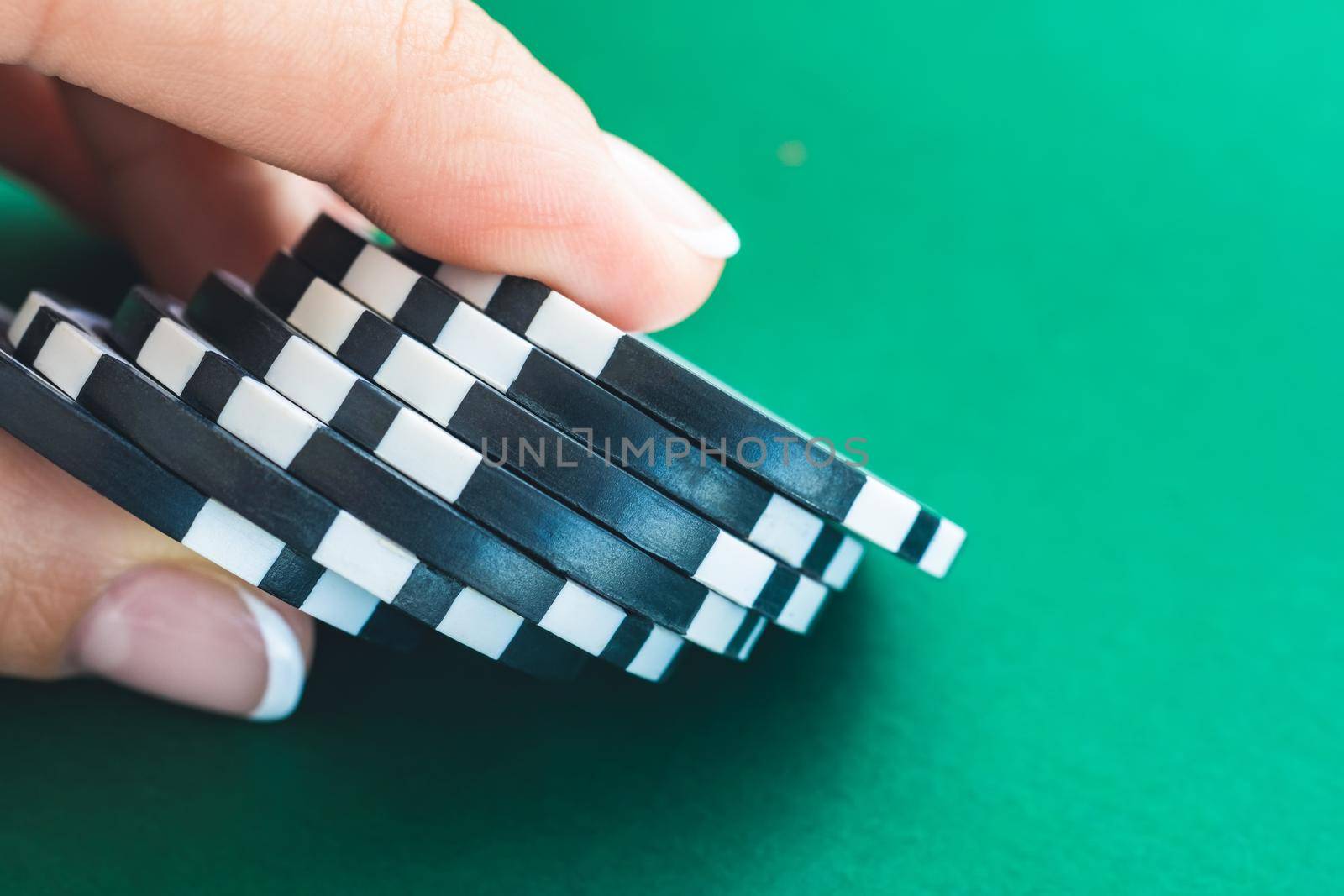 Stack of gambling chips in girl's hand