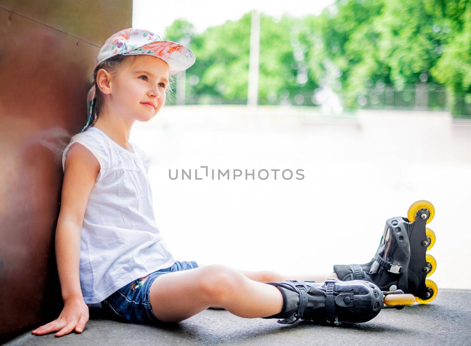 Beautiful little girl on roller skates in park