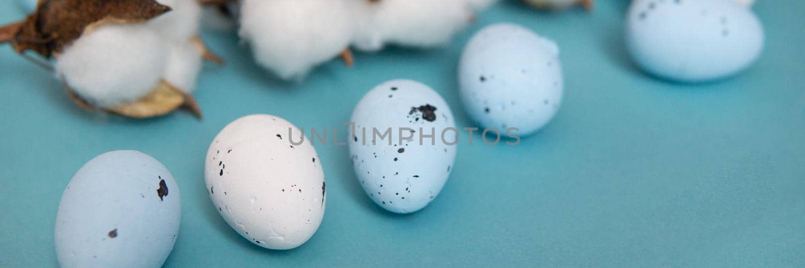 Easter background. Blue and white painted quail eggs on a blue background by Annu1tochka