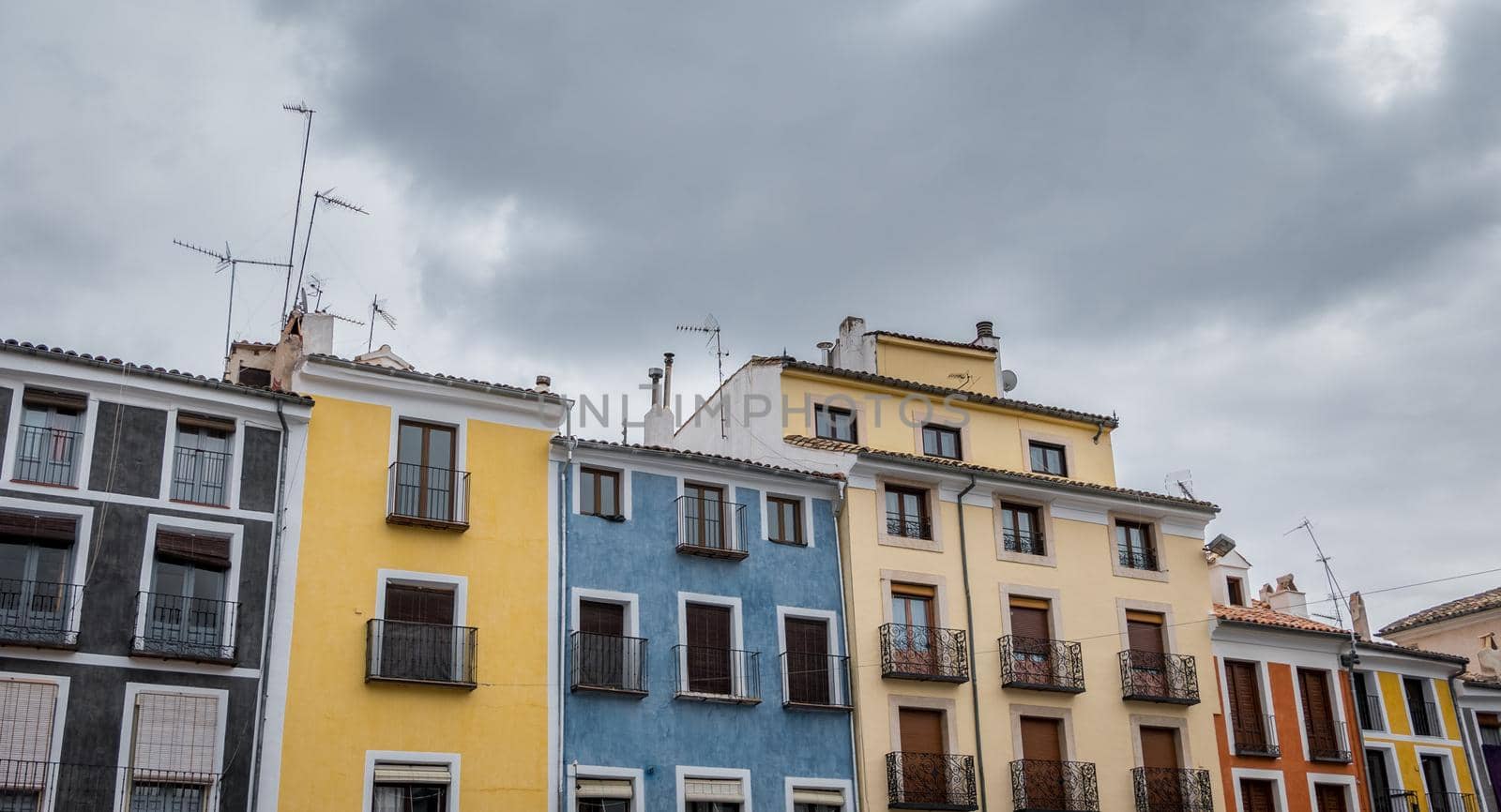 Top of colorful houses against cloudy sky