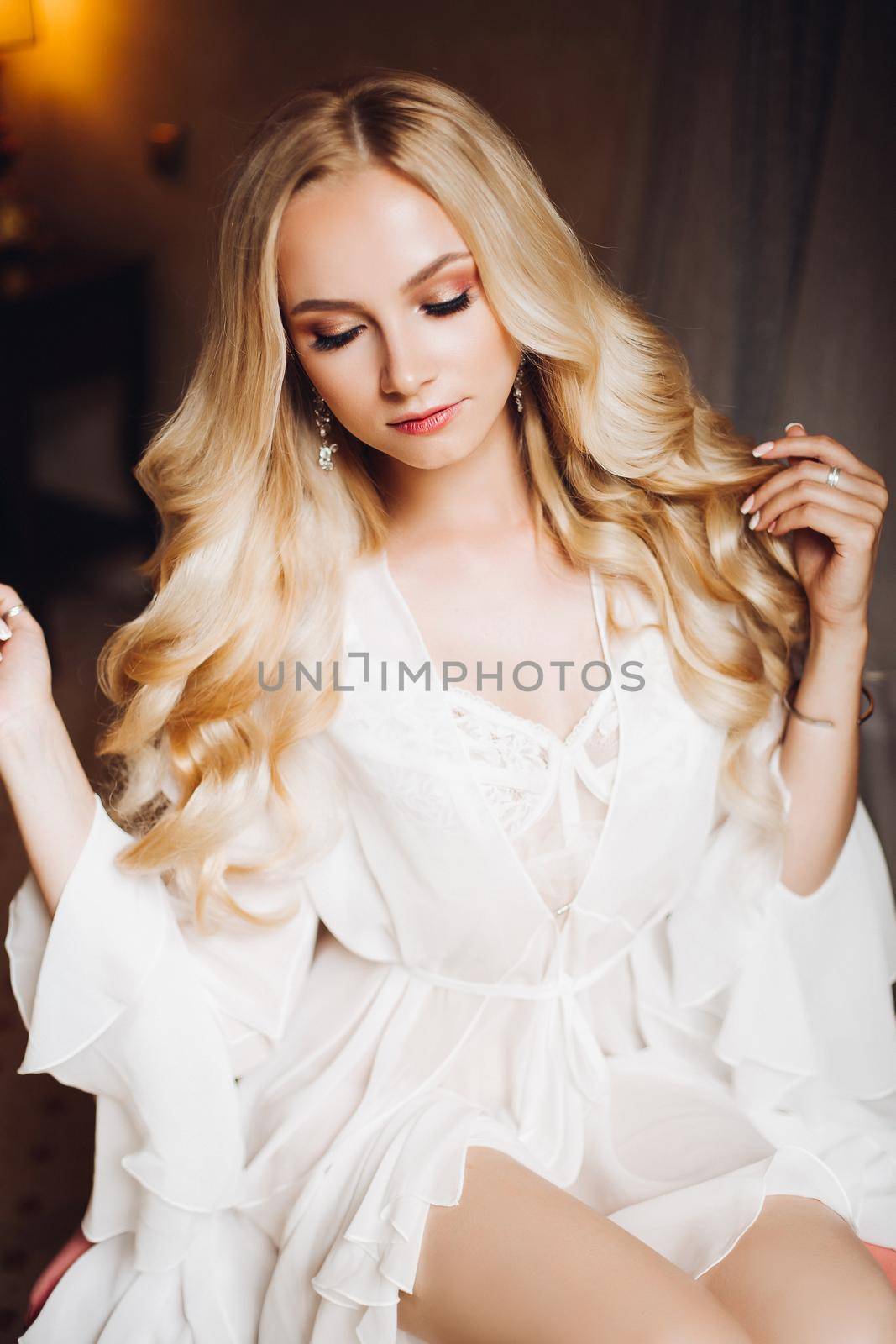 Beautiful blondie bride in bedroom, dreaming with closed eyes. by StudioLucky